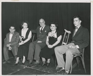 Seated men and women posing at the signing of the scroll celebration