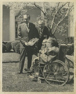 Richard M. Nixon, accompanied by Harold Russell, presents the 1970 President's Trophy to Richard and Robert Santin