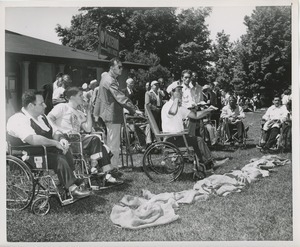 Men in wheelchairs outside during annual outing