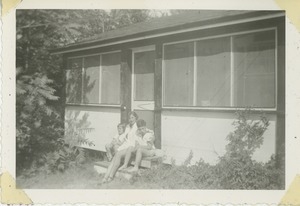 Bernice Kahn with son Paul and daughter Sharon sitting outside a screen porch