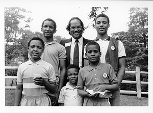 Boston City Councilor Charles Yancey posing with unidentified children at the Franklin Park Zoo