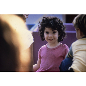 Child in pink shirt smiling