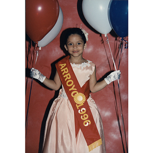 A little girl wears an Arroyo 1996 sash during the Puerto Rican Festival