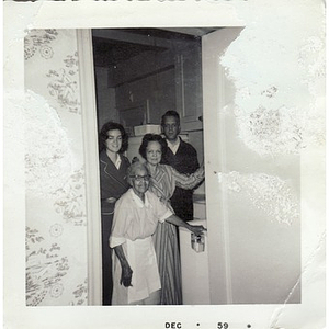 An elderly housekeeper poses with her employers