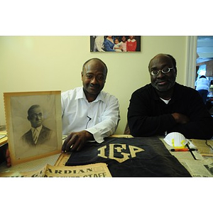 Stephen Hunter and David F. Hunter pose with a photograph of their father, Laymon Hunter