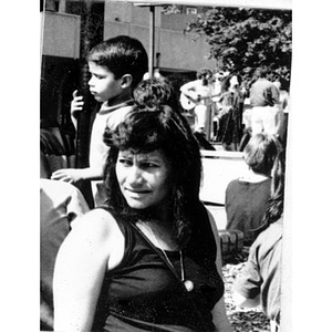 Portrait of a woman in a crowd of spectators watching an outdoor concert.