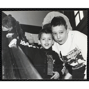 Two boys posing for the camera, one of them wears "DRUG FREE AND PROUD TO BE" ribbon, at a joint Charlestown Boys & Girls Club and Charlestown Against Drugs (CHAD) event