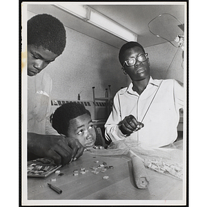 Three boys working on projects for their arts and crafts class at the Boys' Clubs of Boston