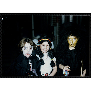 Three children pose in their Halloween costumes