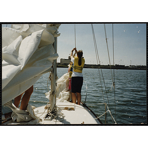 Two girls rig sail on a boat in Boston Harbor