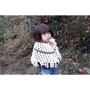 Girl in an orchard during a Chinese Progressive Association trip