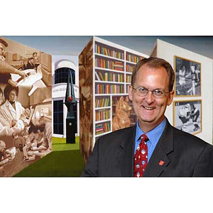 William Bartolini in front of artwork in the Curry Student Center