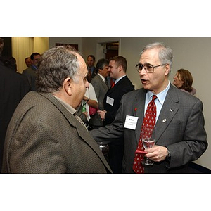 Two unidentified men converse at The National Council Dinner