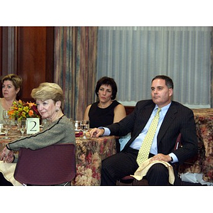 Joseph Malarny, CBA '82, right, and Denise DiCenso, second from left, listening to speaker at the College of Business Administration's Distinguished Service Awards ceremony