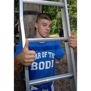 Joseph Bordieri gives a thumbs-up at the Torch Scholars Project Adventure Ropes Course