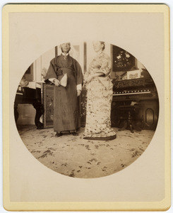 C. P. Blanchard and Abby F. Blanchard in the parlor, wearing kimonos