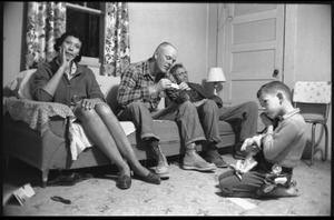 Mildred and Richard Loving (from left) seated on a couch with Richard's father, their son Donald seated on the floor in a cowboy outfit, playing with a puppy