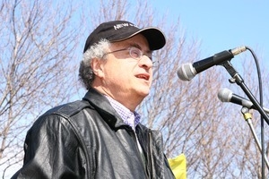 Unidentified speaker at the microphone, addressing protesters: rally and march against the Iraq War