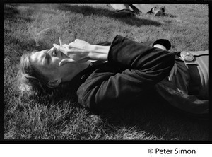 Livingston Taylor, lying on the lawn, smoking a cigarette
