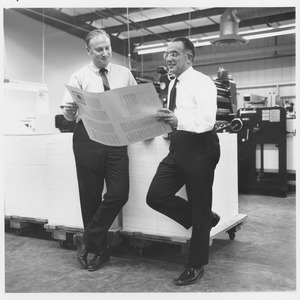 Edwin Rossman and unidentified man examining a print run in press room