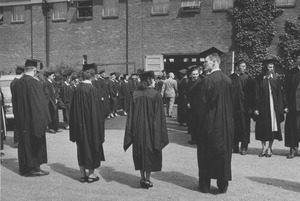 Graduates form a path into Curry Hicks Cage