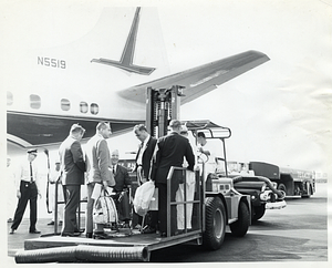 Mayor John F. Collins and unidentified men beside airplane