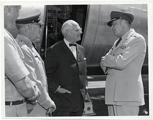 Mark Bortman and U.S. Air Force personnel in front of an airplane