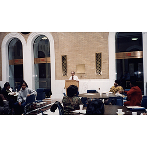 A man speaks at the lectern at a town hall meeting