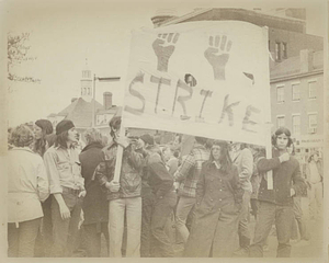 Crowd marches with "Strike" banner