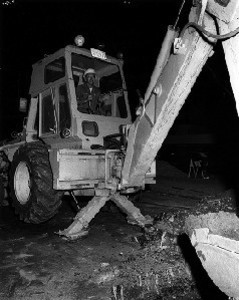 Employee operating bulldozer at the corner of Harrison Avenue and East Berkeley Street