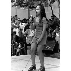 Young female singer performing on the outdoor stage at Festival Betances.