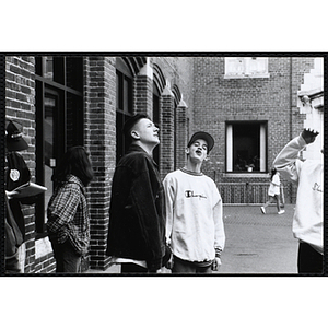 Several teenage boys standing outside the Charlestown Boys and Girls Club building