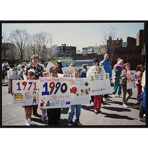 Several boys and girls pose with their parade signs at the Boys and Girls Clubs of Boston 100th Anniversary Celebration Parade