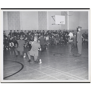 The Boston University drill team perform a maneuver in a gymnasium