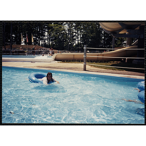 A girl rides on an intertube in a Water Country water park swimming pool during a Tri-Club field trip