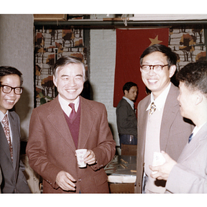 Men socialize at a gathering for the Consul General of Guangdong Province