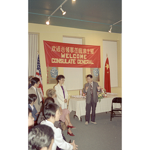 Suzanne Lee stands beside a member of the Consulate General of the People's Republic of China who speaks at a welcome party hosted by the Chinese Progressive Association in Boston