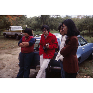 People preparing to pick apples on a Chinese Progressive Association trip