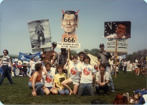 UMass Peacemakers contingent at the 'Four Days in April' demonstration in Washington D.C., holding image of Ronald Reagan with devil's horns and caption '666 The bombing begins in five minutes'