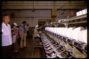 Cotton mill: operator at a spinning machine