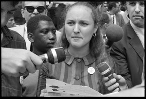 Unidentified woman speaking with reporters during the Assembly of Unrepresented People anti-war march