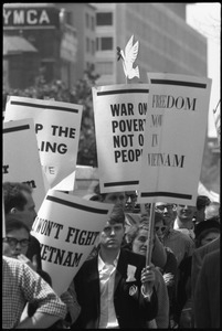 Antiwar protesters during the March on Washington carrying signs 'Freedom now in Vietnam,' 'War on Poverty, not on people,' and 'I won't fight in Vietnam'