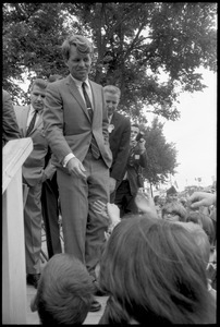 Robert F. Kennedy looking at the crowd from atop the stage while stumping for Democratic candidates in the northern Midwest