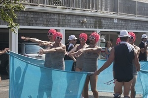 Parade marchers dressed as synchronized swimming team in makeshift swimming pool : Provincetown Carnival parade
