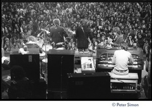 Bob Dylan, Robbie Robertson, and Garth Hudson (from left) performing on stage at the Boston Garden with The Band