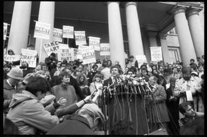 Gary Hart at a microphone-encrusted podium, addressing an crowd after renewing his bid for the Democratic nomination for the presidency