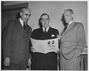 Henry Van Roekel, R.A. Hendershott, and F.R. Beaudette discussing report