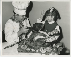 Chef handing turkey leg to a young client