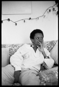 Cuban writer Nancy Morejón, in contemplative pose, seated on a couch
