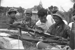 Lt. Colonel Le Duc Dat with captured Vietcong weapons including Czechoslovakian automatic rifle.